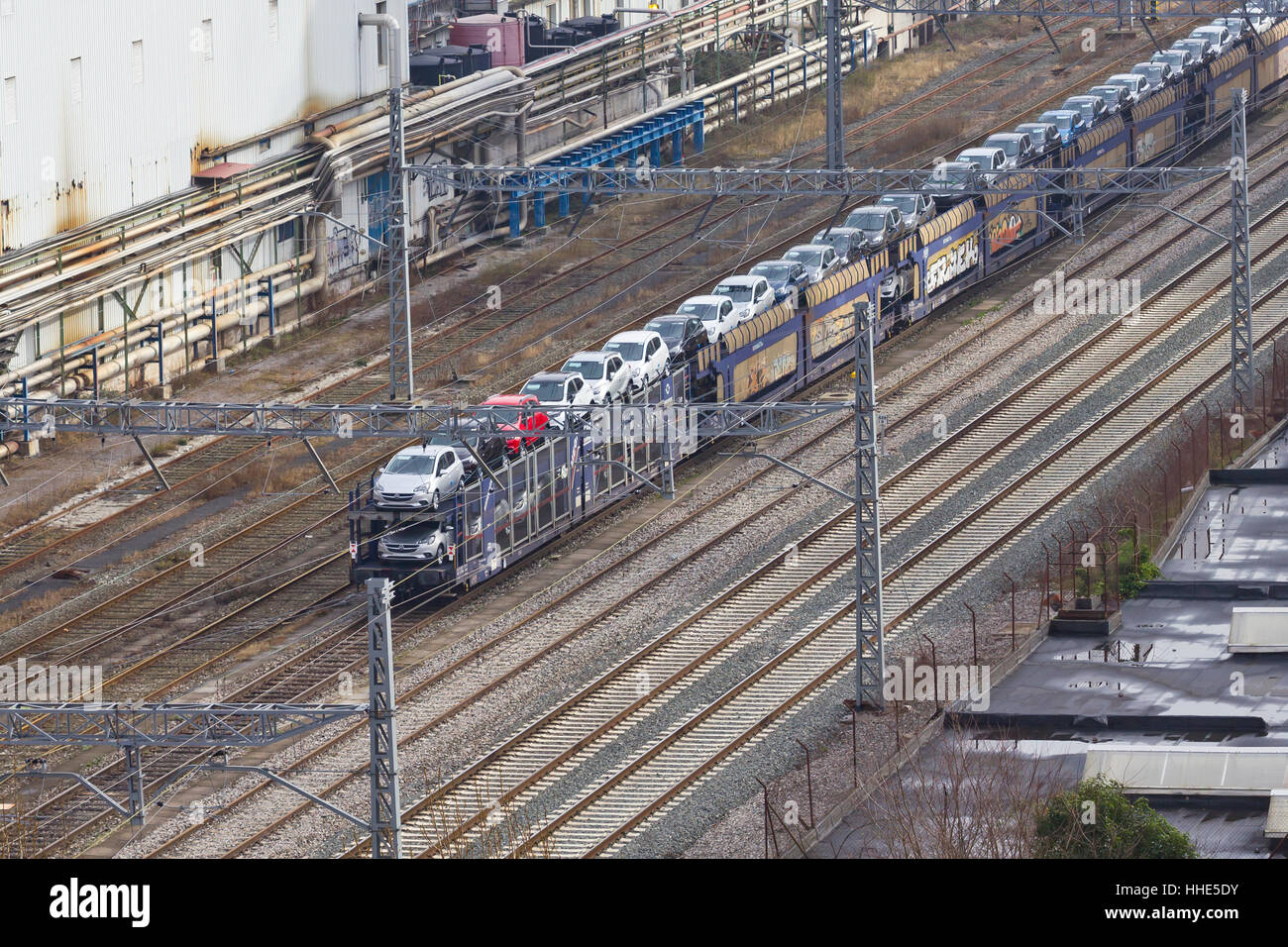 Train carrying new Opel cars in Guipuzcoa (Basque country, Spain). Stock Photo