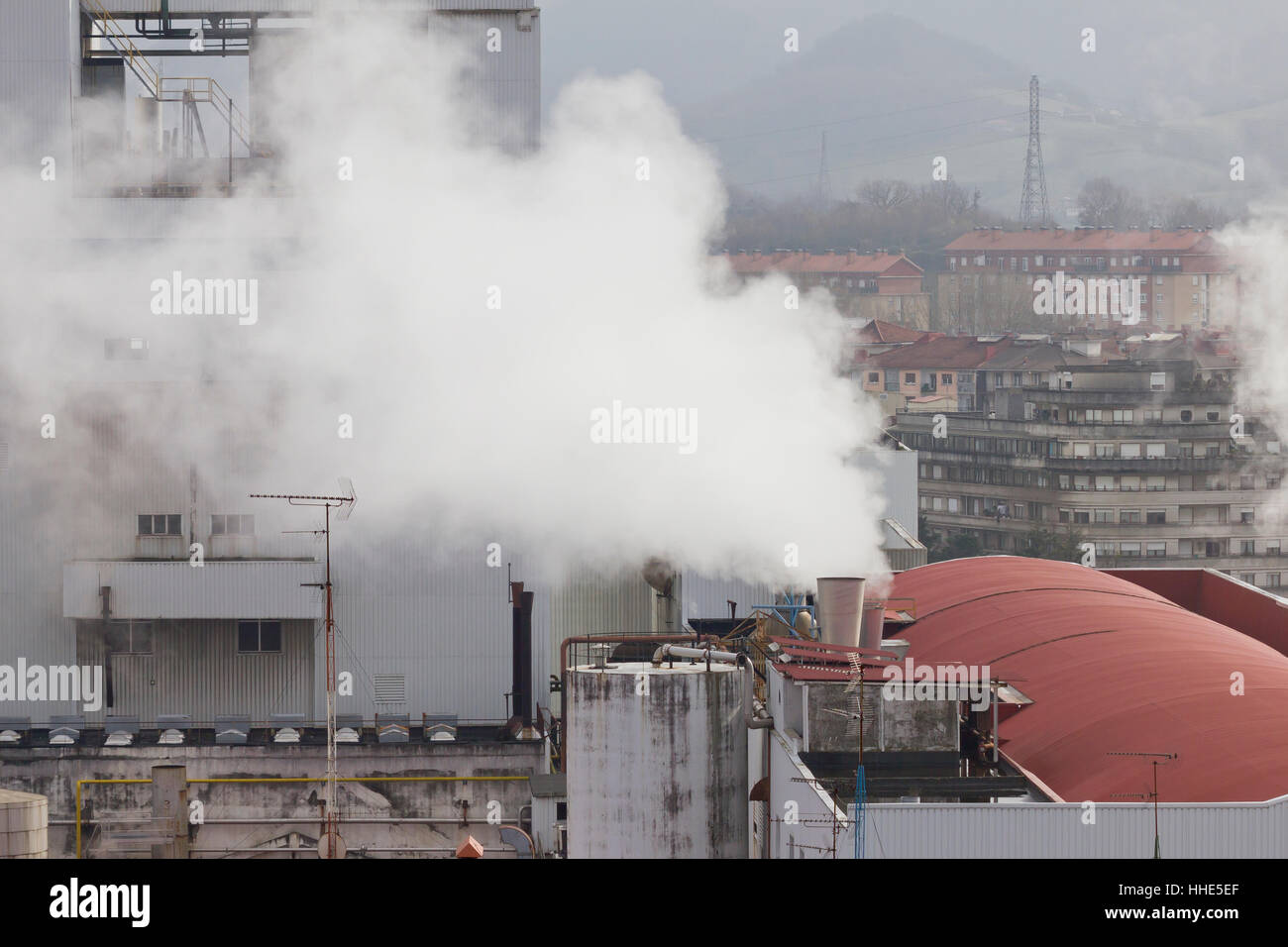 Industrial chimney emitting greenhouse gases. Stock Photo