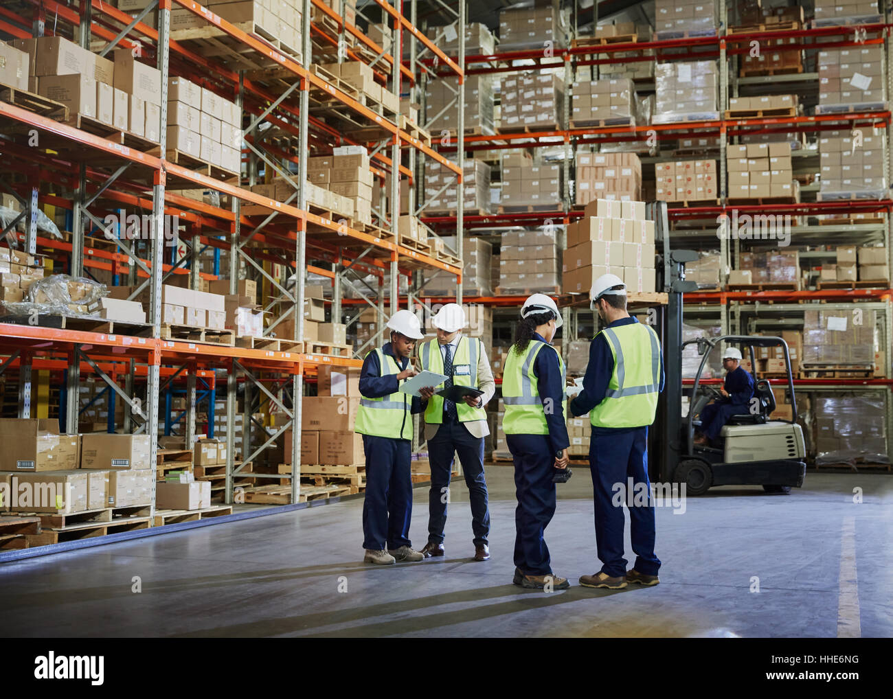 Workers meeting and talking in distribution warehouse Stock Photo - Alamy