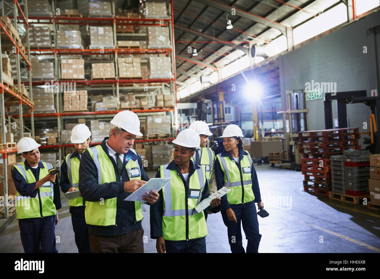 Manager and workers talking in distribution warehouse Stock Photo - Alamy