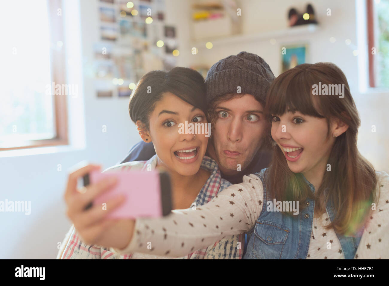 Playful young friends taking selfie making silly faces Stock Photo
