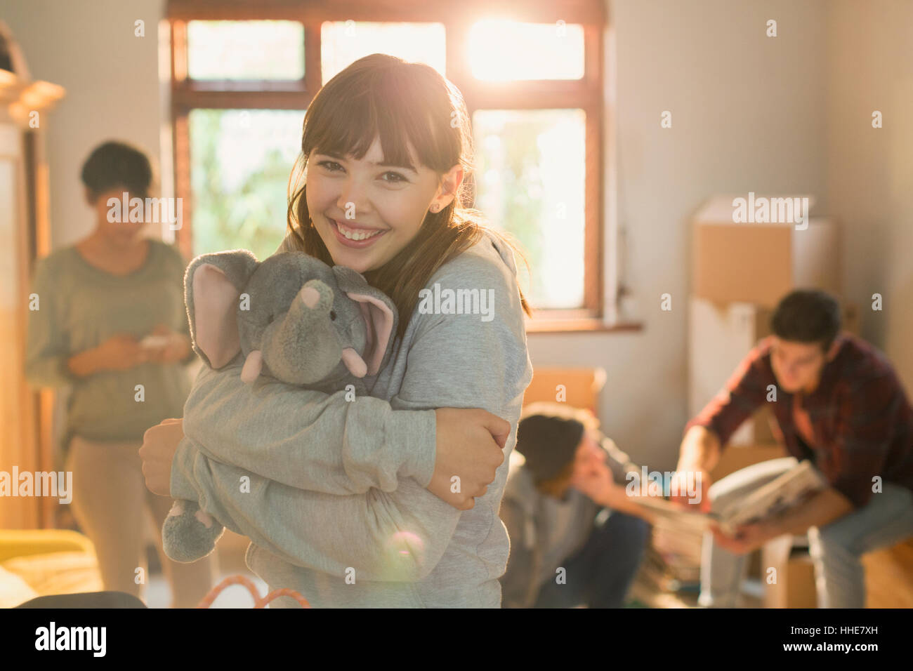 Portrait smiling young woman hugging stuffed elephant Stock Photo