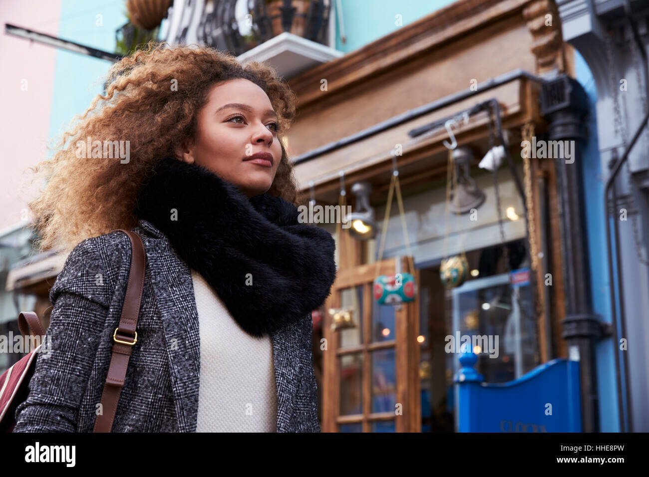 Stylish Young Woman Walking Along Busy City Street Stock Photo - Alamy
