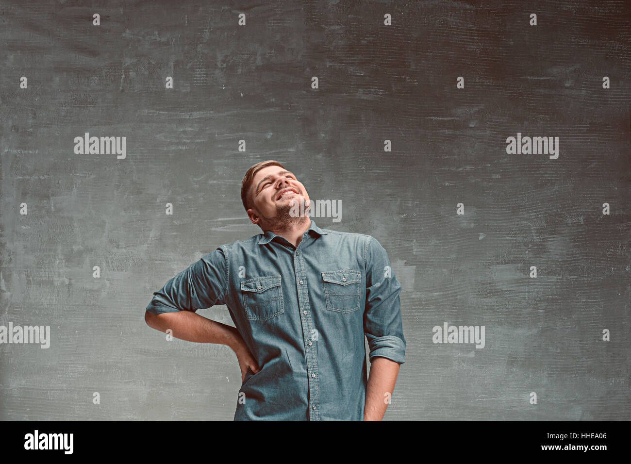 Portrait of smiling happy man standing in studio Stock Photo - Alamy