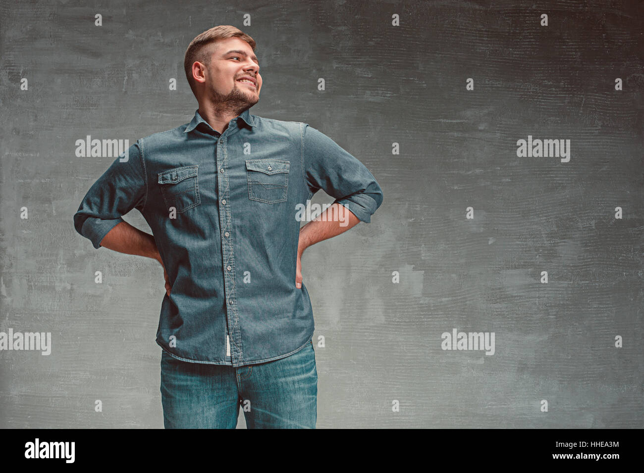 Portrait of smiling happy man standing in studio Stock Photo - Alamy