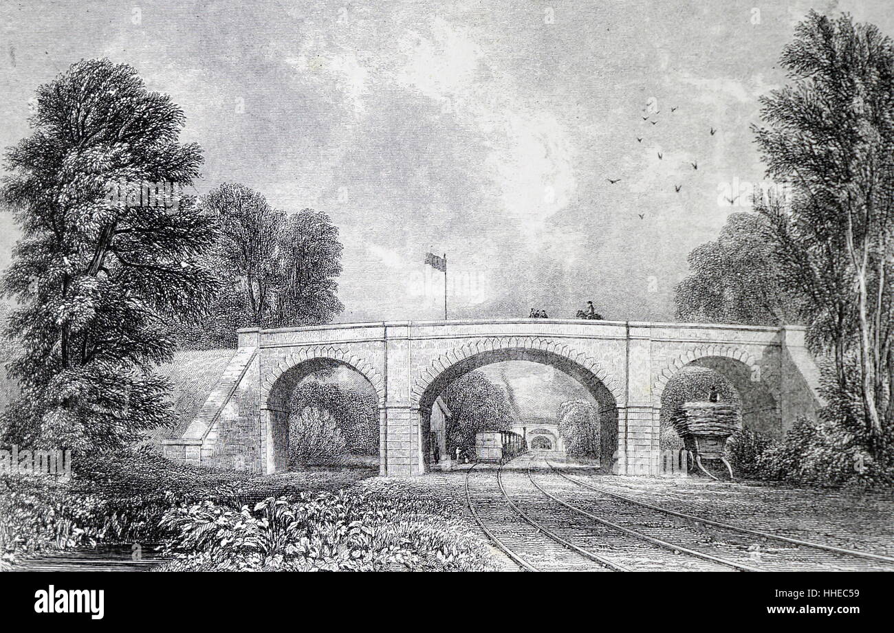 London and Birmingham Railway. Road bridge over the line at Newton Road Station near Birmingham, England, train in Station in the distance. 1839 Stock Photo