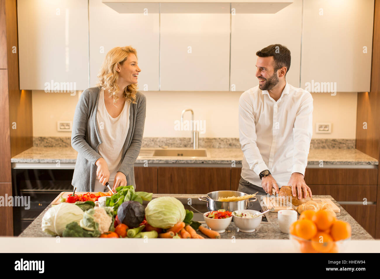 Young loving couple  preparing  tasty meal in a modern kitchen Stock Photo