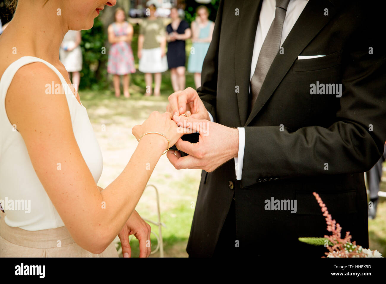 A just married couple exchanging wedding rings Stock Photo