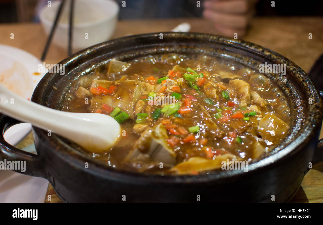 Spicy steamed tofu in the stone bowl Stock Photo