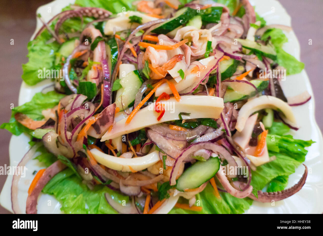 Seafood salad with squid and vegetables on the plate Stock Photo