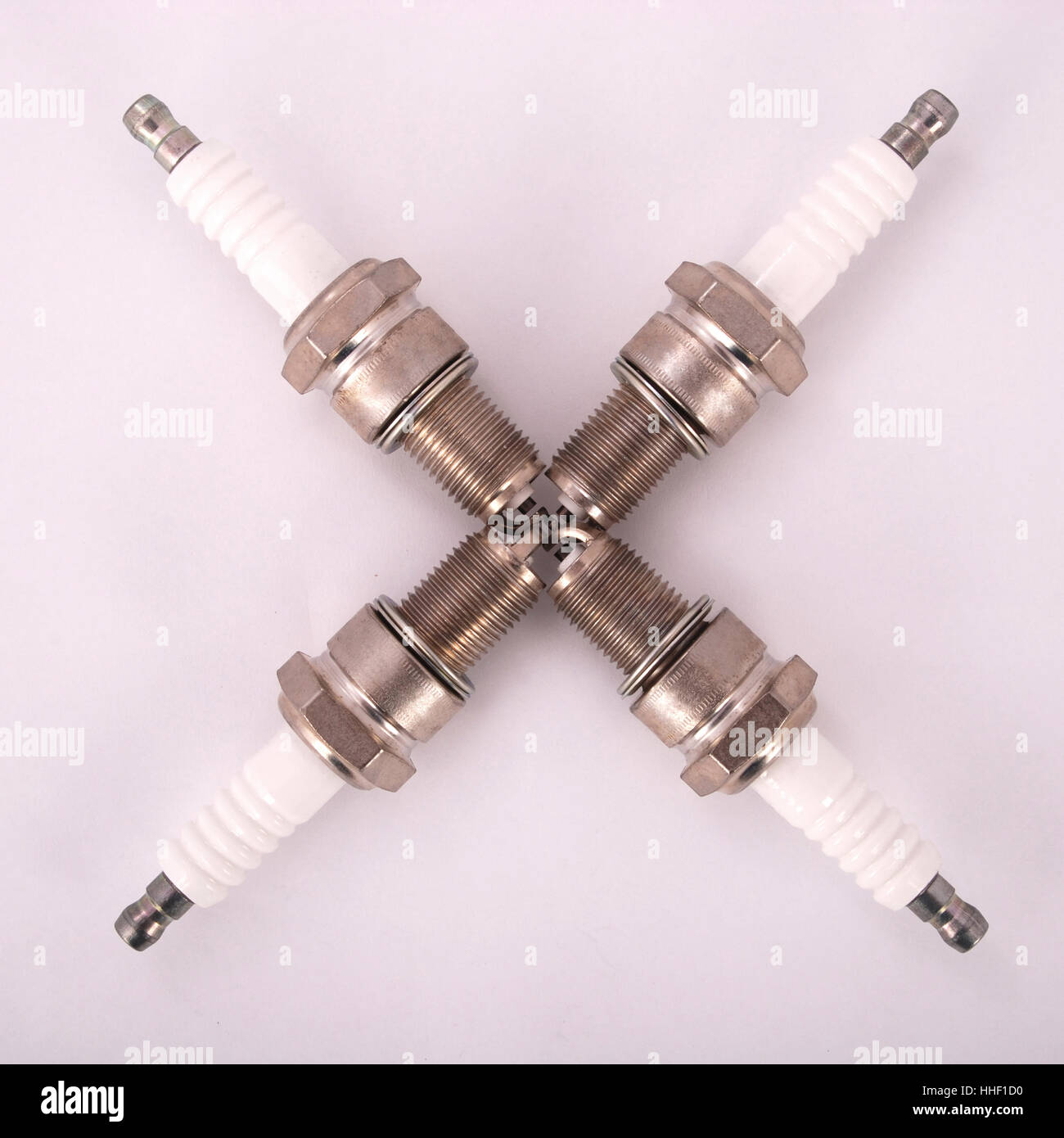 Four new spark plugs on a gray background Stock Photo Alamy