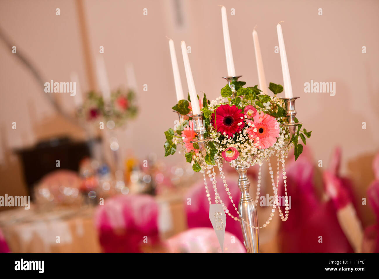 Support for candles with flowers on the table in natural light Stock Photo