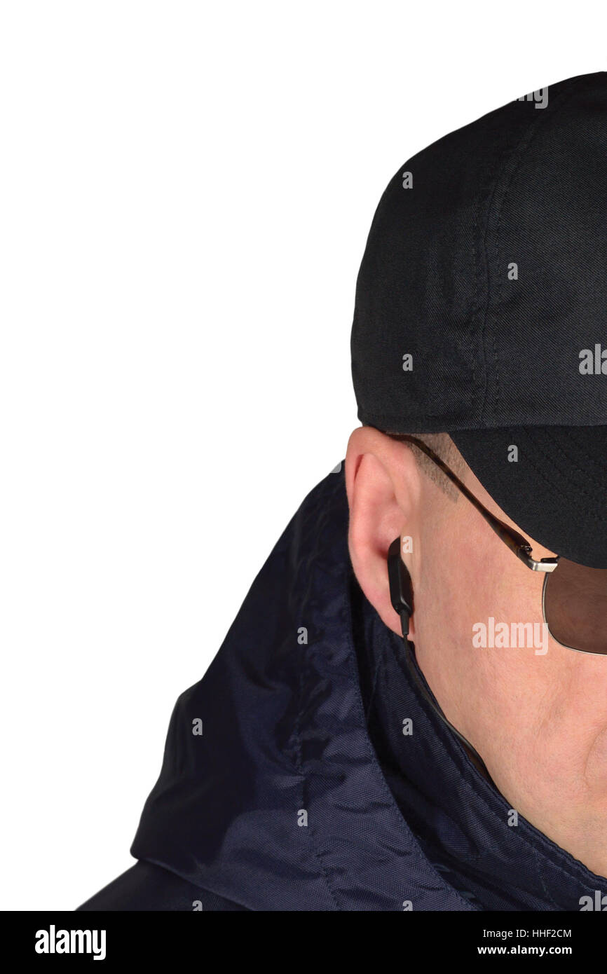 Police security guard staff policeman covertly listening on specop field situation, isolated undercover agent covert operations surveillance earpiece Stock Photo