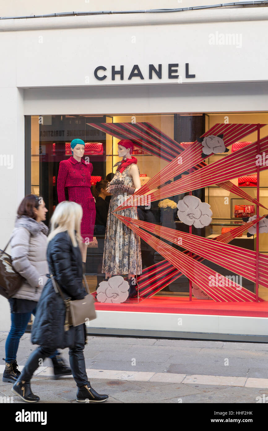 Two women walking past the Chanel window display, Venice, Veneto, Italy Stock Photo