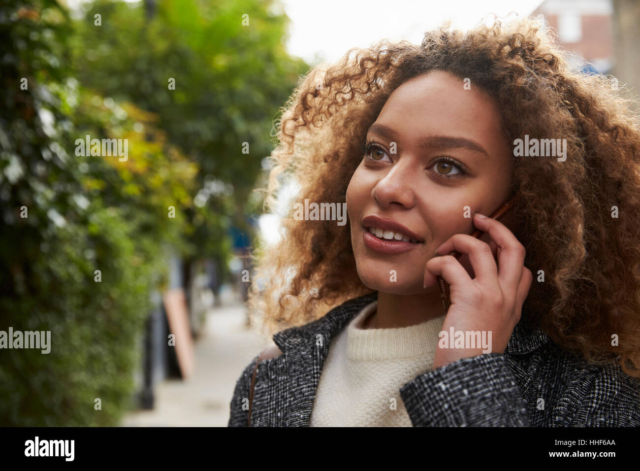 Stylish Young Woman Making Phone Call On City Street Stock Photo