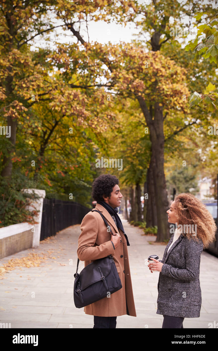 Stylish Young Couple Talking On Fall Street In City Stock Photo