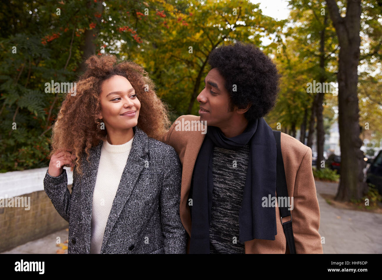 Romantic Young Couple Walking On Fall Street In City Stock Photo