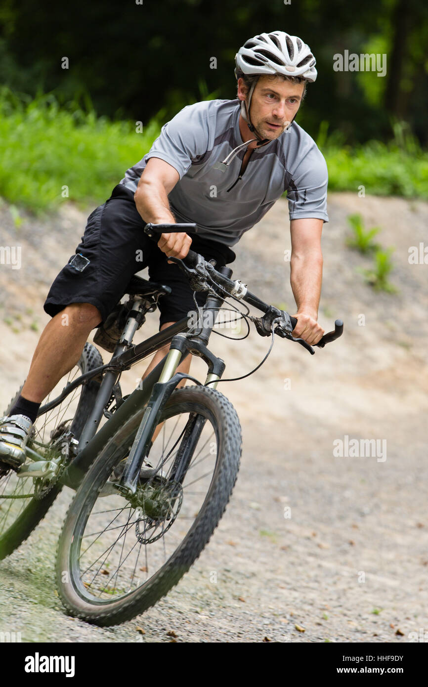mountain bikers in an inclined position in downhill Stock Photo