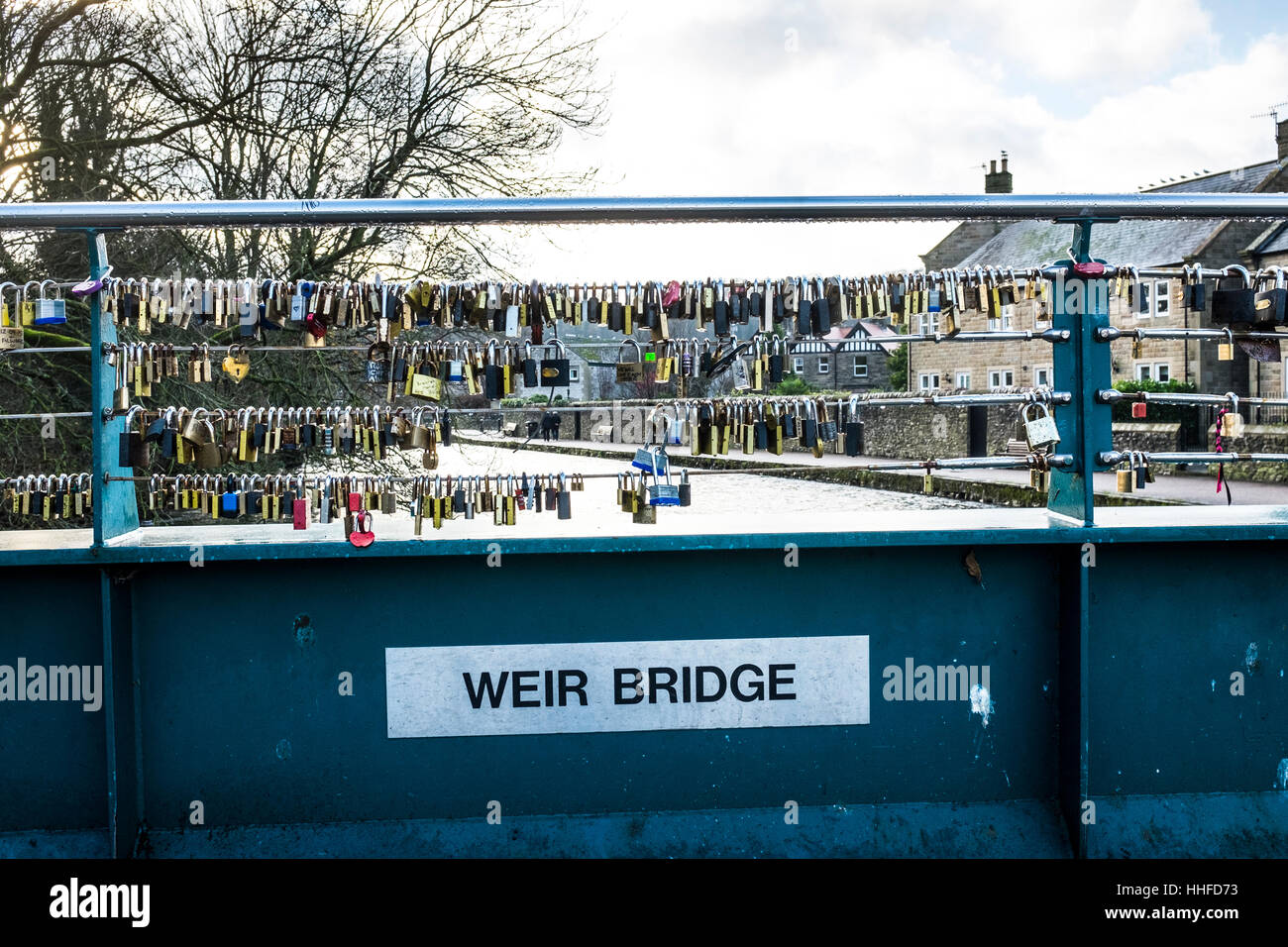 Padlocks attached to the cabling of the Weir Bridge over the River Wye in Bakewell, Derbyshire
