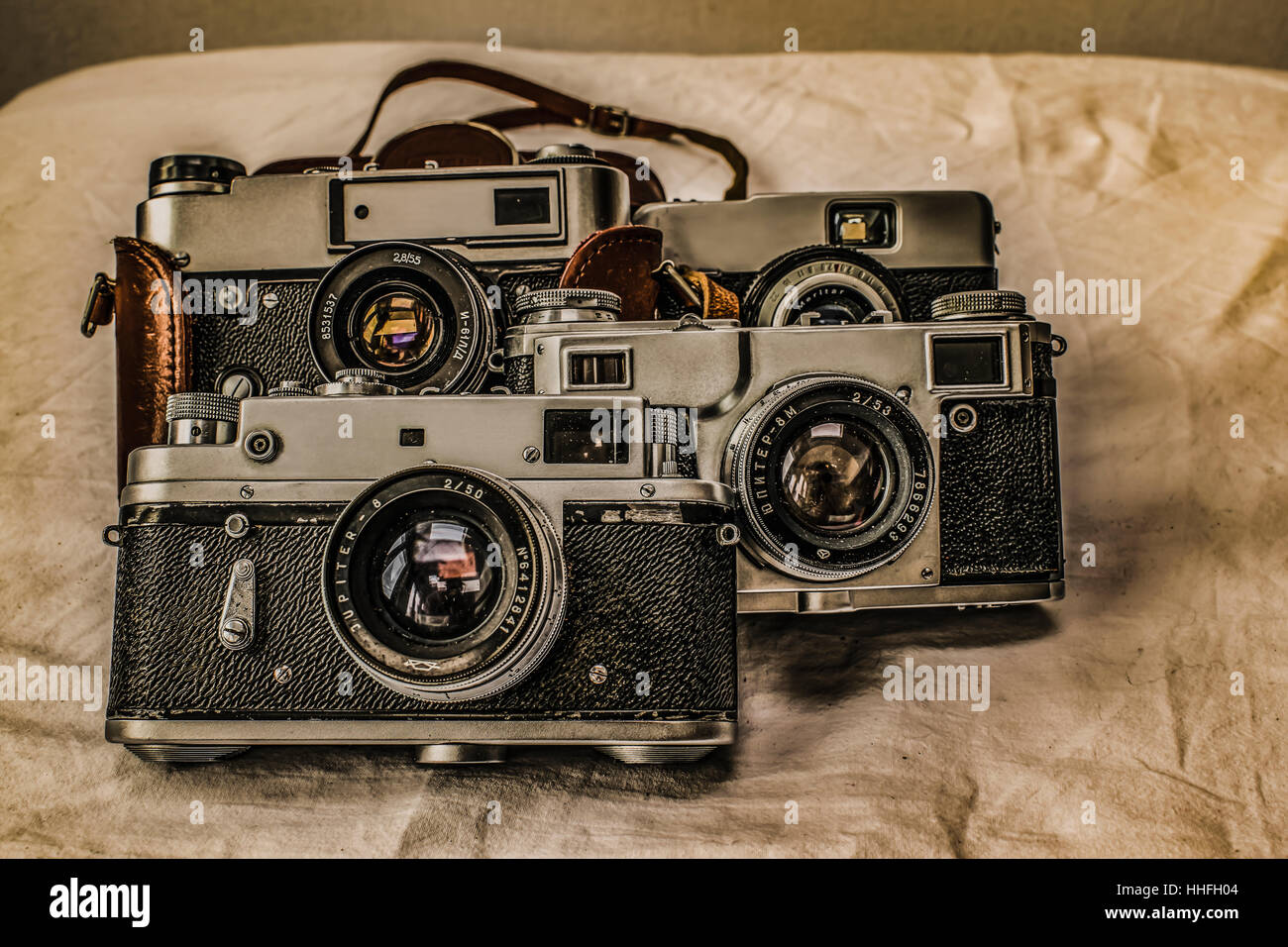 Old Russian classic analog film cameras with manual controls on dirty canvas with vintage look Stock Photo