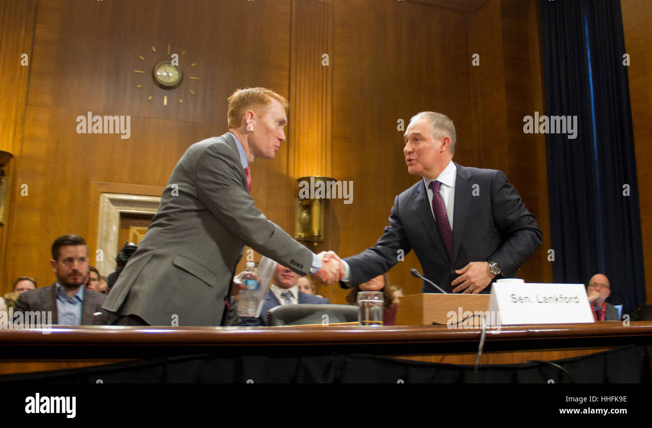 Washington DC, USA. 18th January 2017. Oklahoma Attorney General Scott Pruitt shakes hands with Sen Jjames Lankford (R-OK). Pruitt was  President-elect Donald Trump's choice to head the Environmental Protection Agency, testifies during his confirmation hearing before the Senate Committee on Environment and Public Works on Capitol Hill January 18, 2017 in Washington, DC. Pruitt is expected to face tough questioning about his stance on climate change and ties to the oil and gas industry. Credit: PixelPro/Alamy Live News Stock Photo