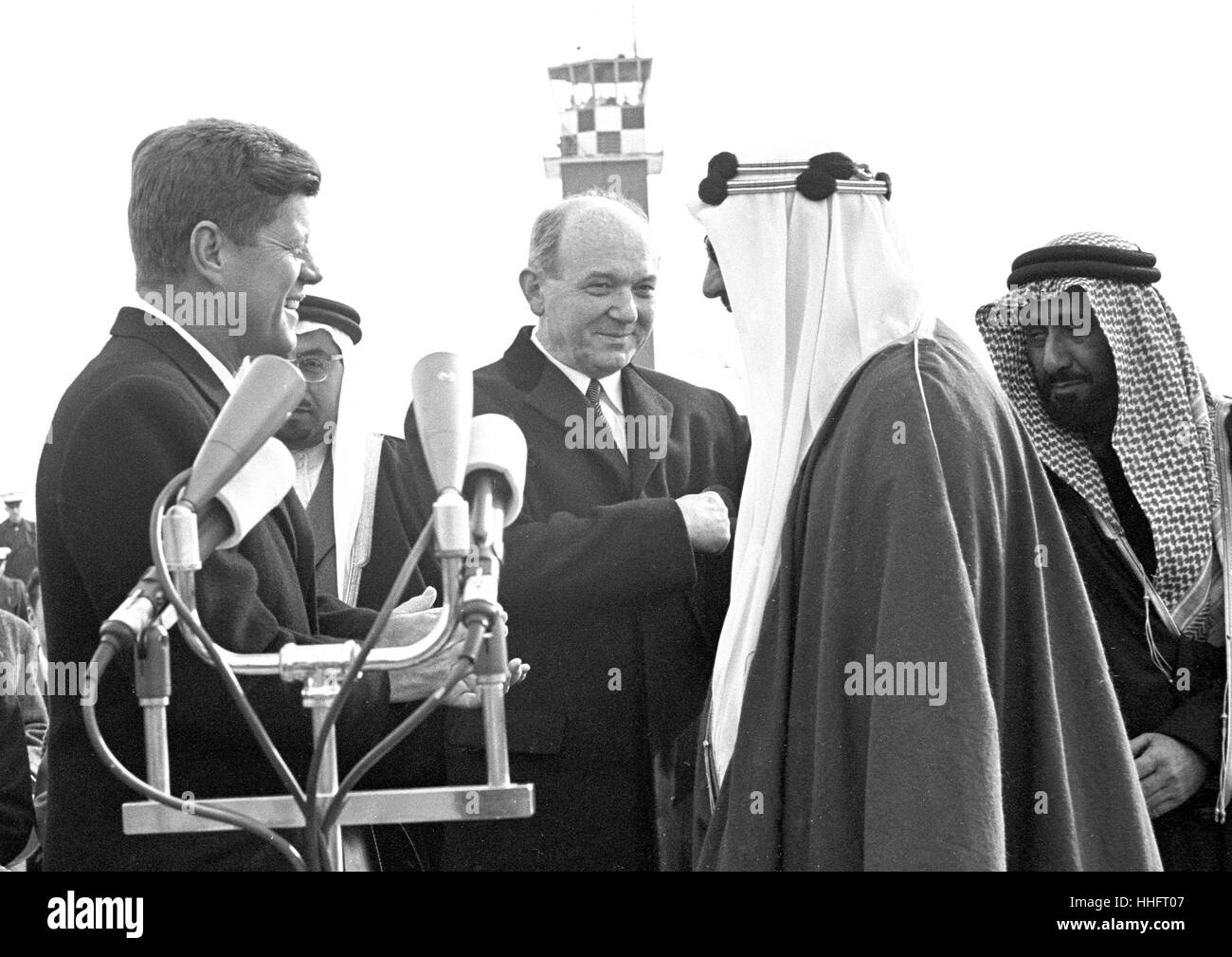 United States President John F. Kennedy, left, and US Secretary of State Dean Rusk, center left, welcome King Saud bin Abdulaziz Al Saud of Saudi Arabia, center right, to the United States following a ceremony at Andrews Air Force Base, Maryland on February 13, 1962. Credit: Arnie Sachs / CNP - NO WIRE SERVICE - Photo: Arnie Sachs/Consolidated/dpa Stock Photo