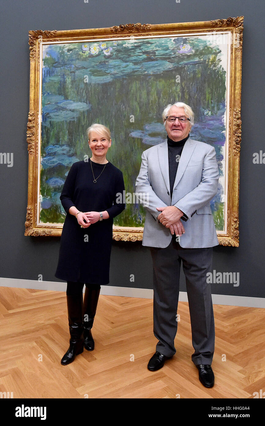 Potsdam, Germany. 19th Jan, 2017. Art patron Hasso Plattner and museum director Ortrud Westheider stand in front of the painting 'Sea Roses' by Claude Monet at the Museum Barberini in Potsdam, Germany, 19 January 2017. The msueum will open on Friday, 20 January 2017, with the exhibition Impressionismus. Photo: Bernd Settnik/dpa-Zentralbild/dpa/Alamy Live News Stock Photo