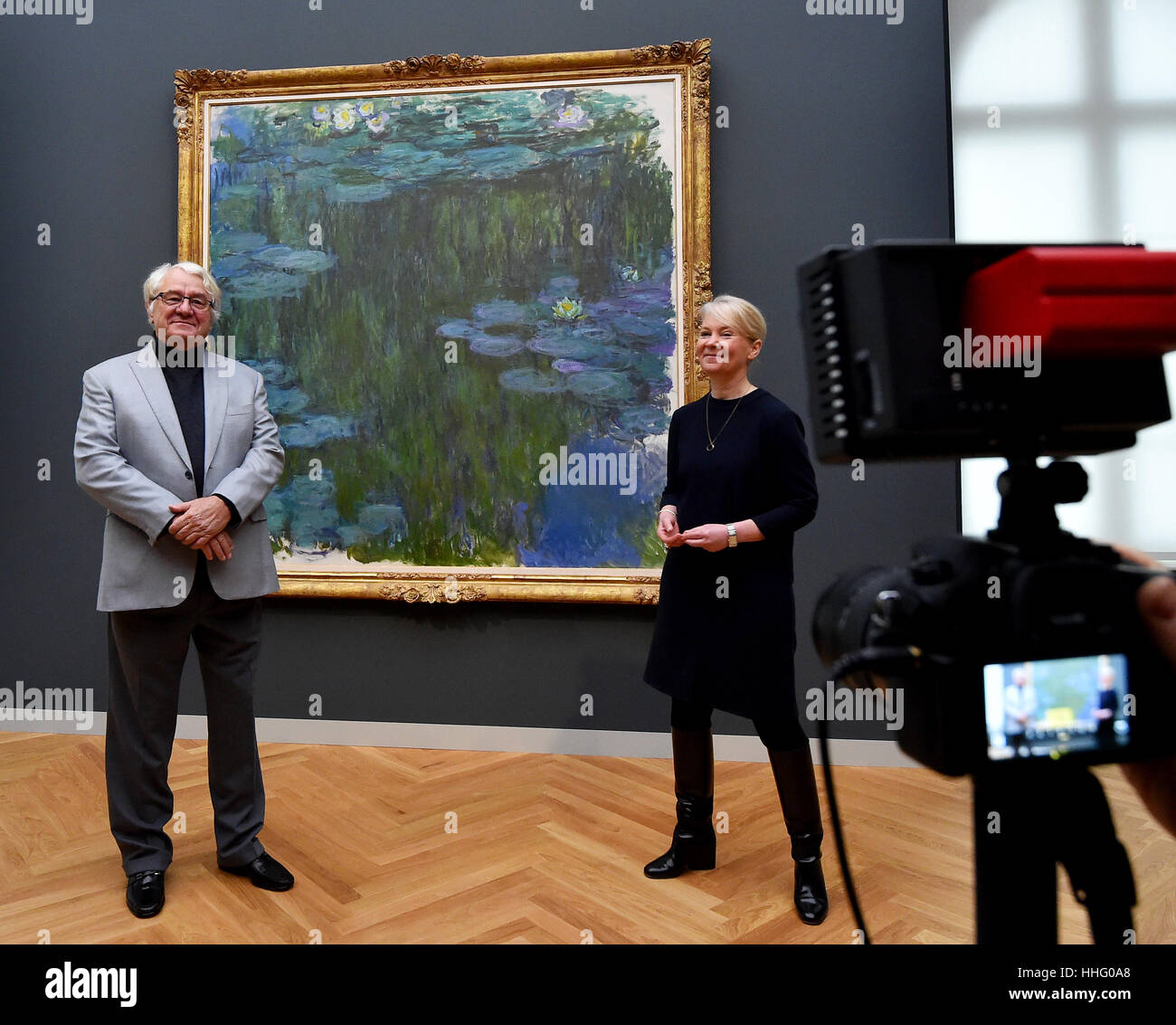 Art patron Hasso Plattner and museum director Ortrud Westheider stand in front of the painting 'Sea Roses' by Claude Monet at the Museum Barberini in Potsdam, Germany, 19 January 2017. The msueum will open on Friday, 20 January 2017, with the exhibition Impressionismus. Photo: Bernd Settnik/dpa-Zentralbild/dpa Stock Photo