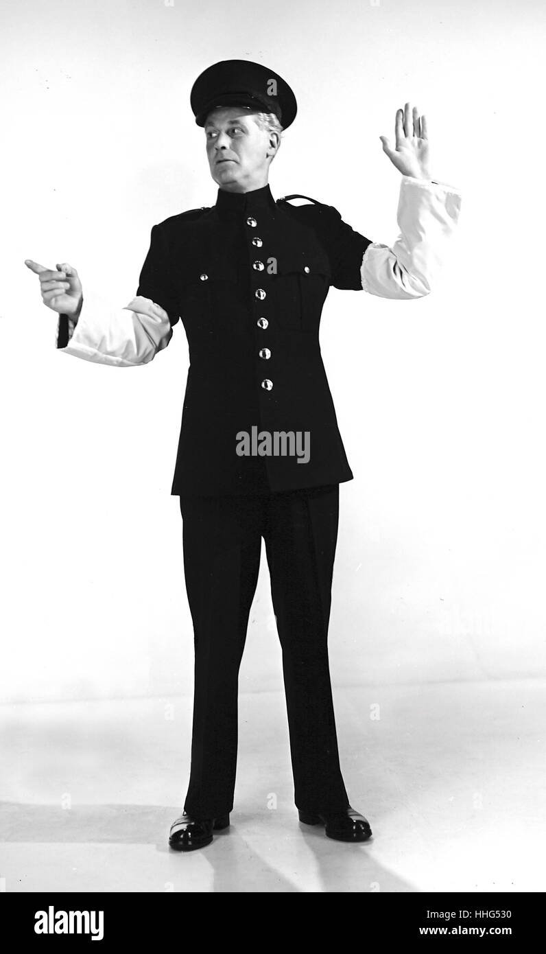 Police uniform produced from a wool/nylon blend, by H. Lottery & co. Ltd. The garment is designed for use by works police patrolmen and transport personnel. The white traffic sleeves are made entirely from continuous filament nylon. 1956 Stock Photo