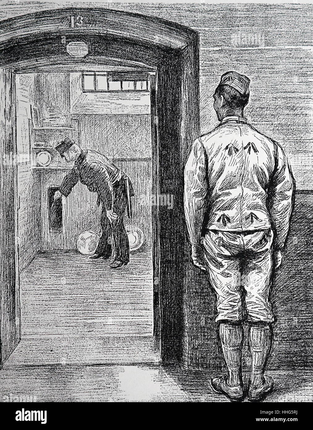 Warder inspects a prison cell, before locking up prisoner for the night. Wormwood scrubs prison, London. Prisoner in uniform with the Broad Arrow motif. London 1889 Stock Photo