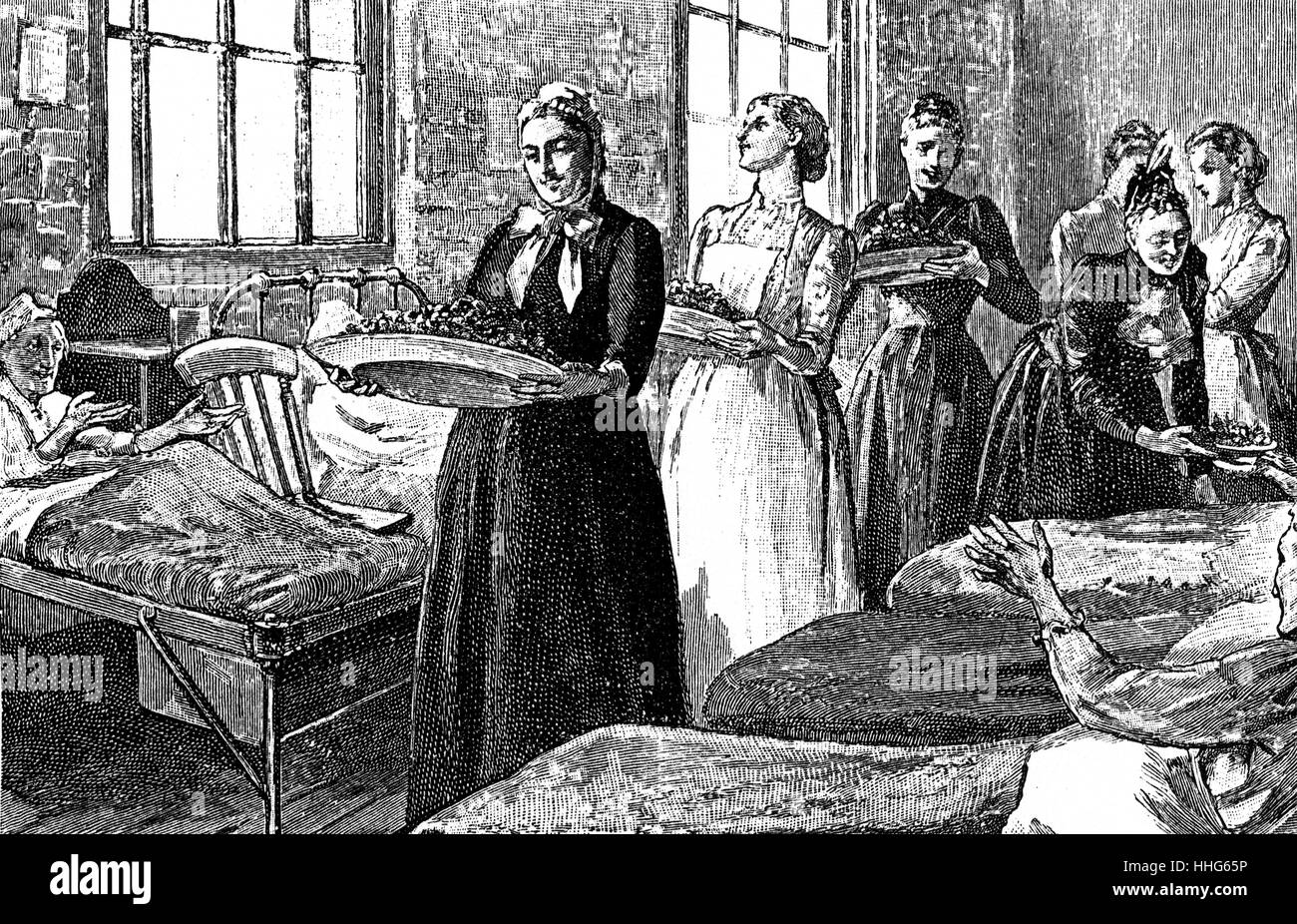 Ladies giving a special Strawberry tea to the female ward in a workhouse. Stock Photo