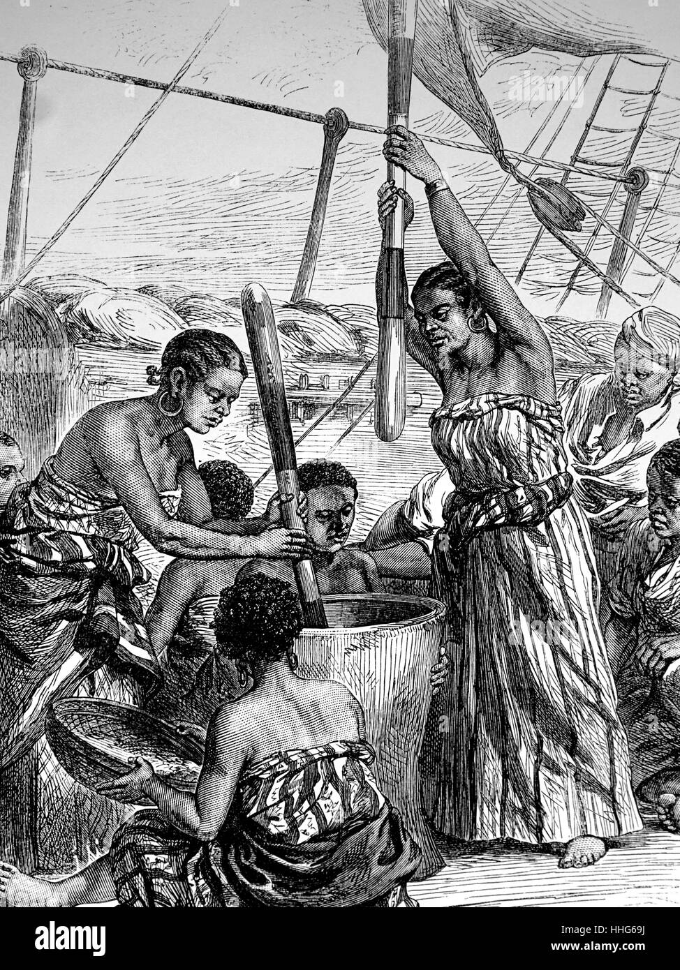 East African women, freed from Arab slave dhows, pounding Millet, on board HMS Lynx. Stock Photo