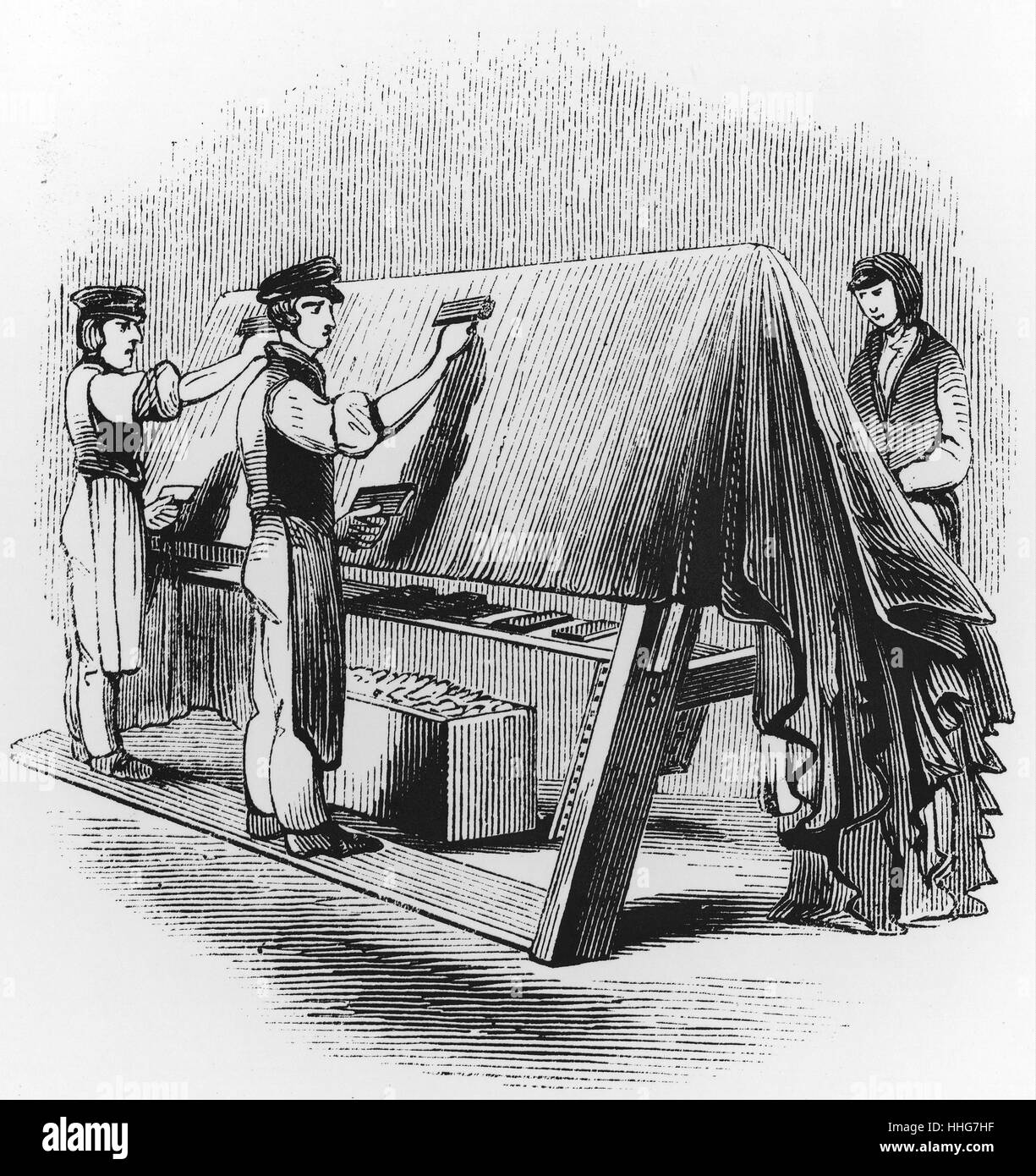 Illustration depicting the hand raising the nap of woollen cloth using Teazles fitted in frames. Dated 19th Century Stock Photo