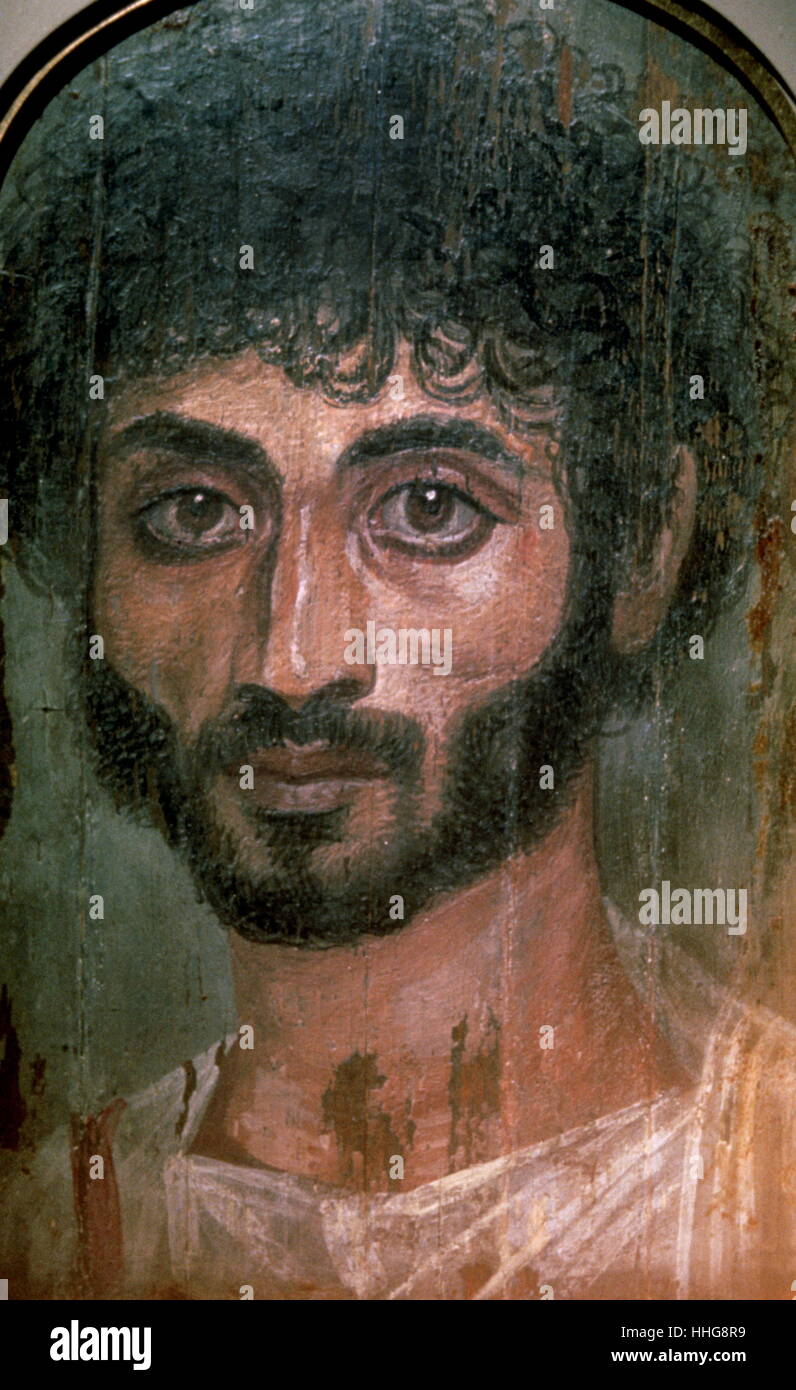 Mummy portrait from Fayum, painted portrait on wooden board attached to a mummy from the Coptic period. the Fayum mummy portraits were an innovation dating to the Coptic period at the time of the Roman occupation of Egypt. They date to the Roman period, from the late 1st century BCE or the early 1st century CE onwards. It is not clear when their production ended, but recent research suggests the middle of the 3rd century. Stock Photo