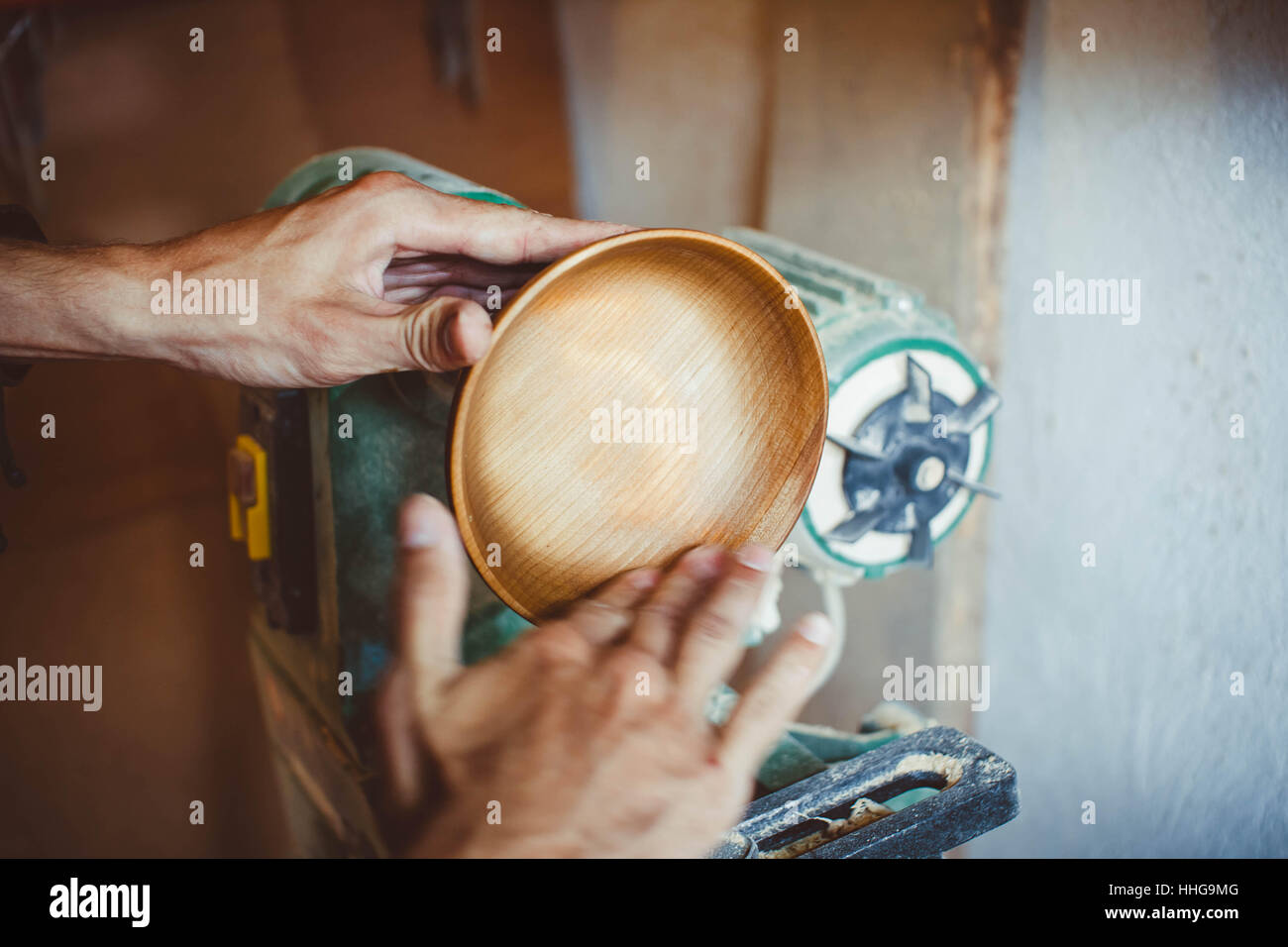 Wood turners using sandpaper polished wood on a lathe Stock Photo Alamy
