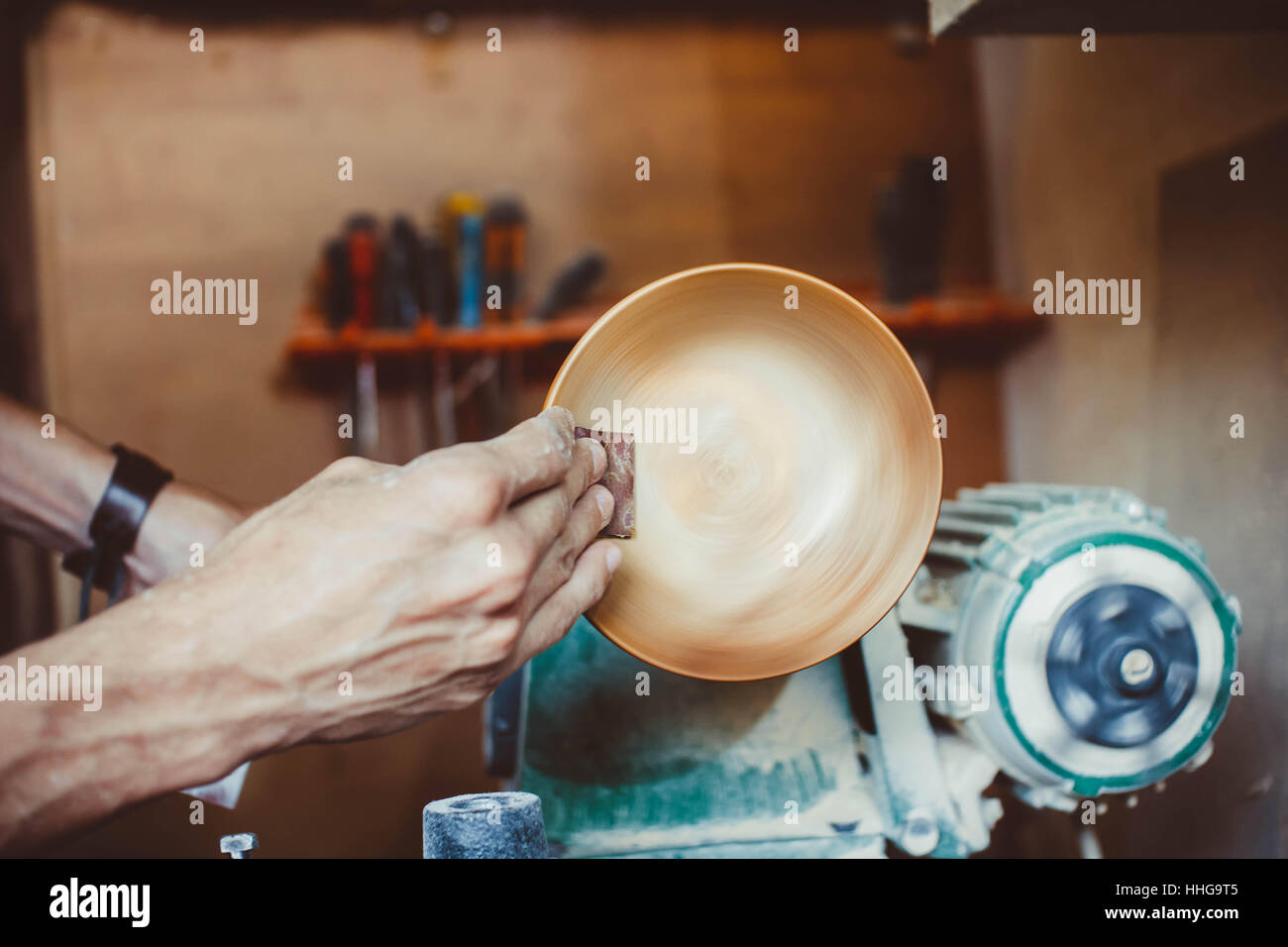 Wood turners using sandpaper polished wood on a lathe Stock Photo Alamy