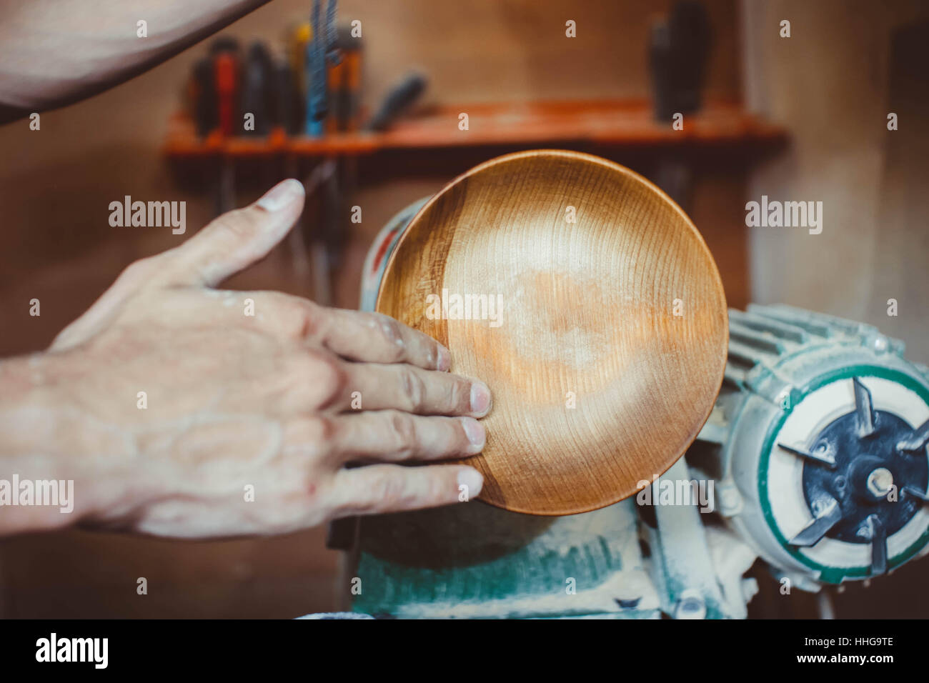 Wood turners using sandpaper polished wood on a lathe Stock Photo Alamy