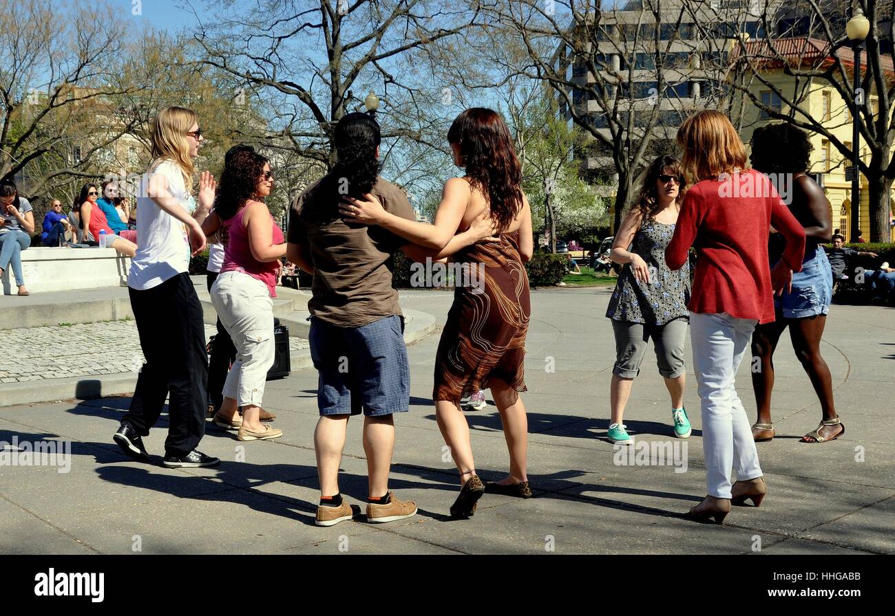 Washington, DC - April 12, 2014:  Group of young people Salsa dancing in the plaza at Dupont Circle on a warm Spring afternoon Stock Photo