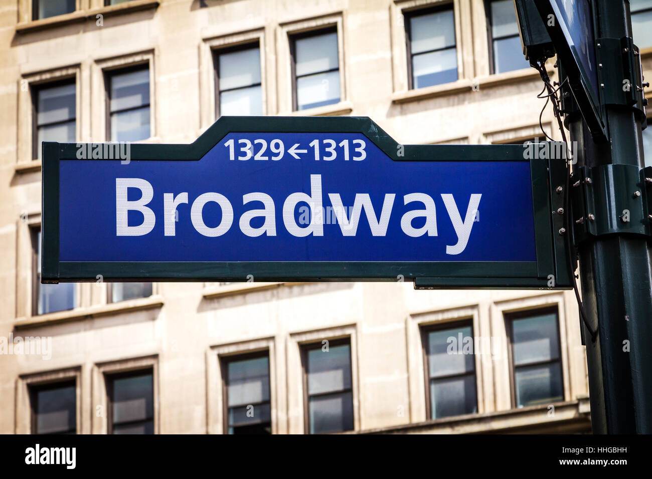 Broadway street sign with building background near 34th Street and Herald Square in Manhattan, New York City NYC Stock Photo