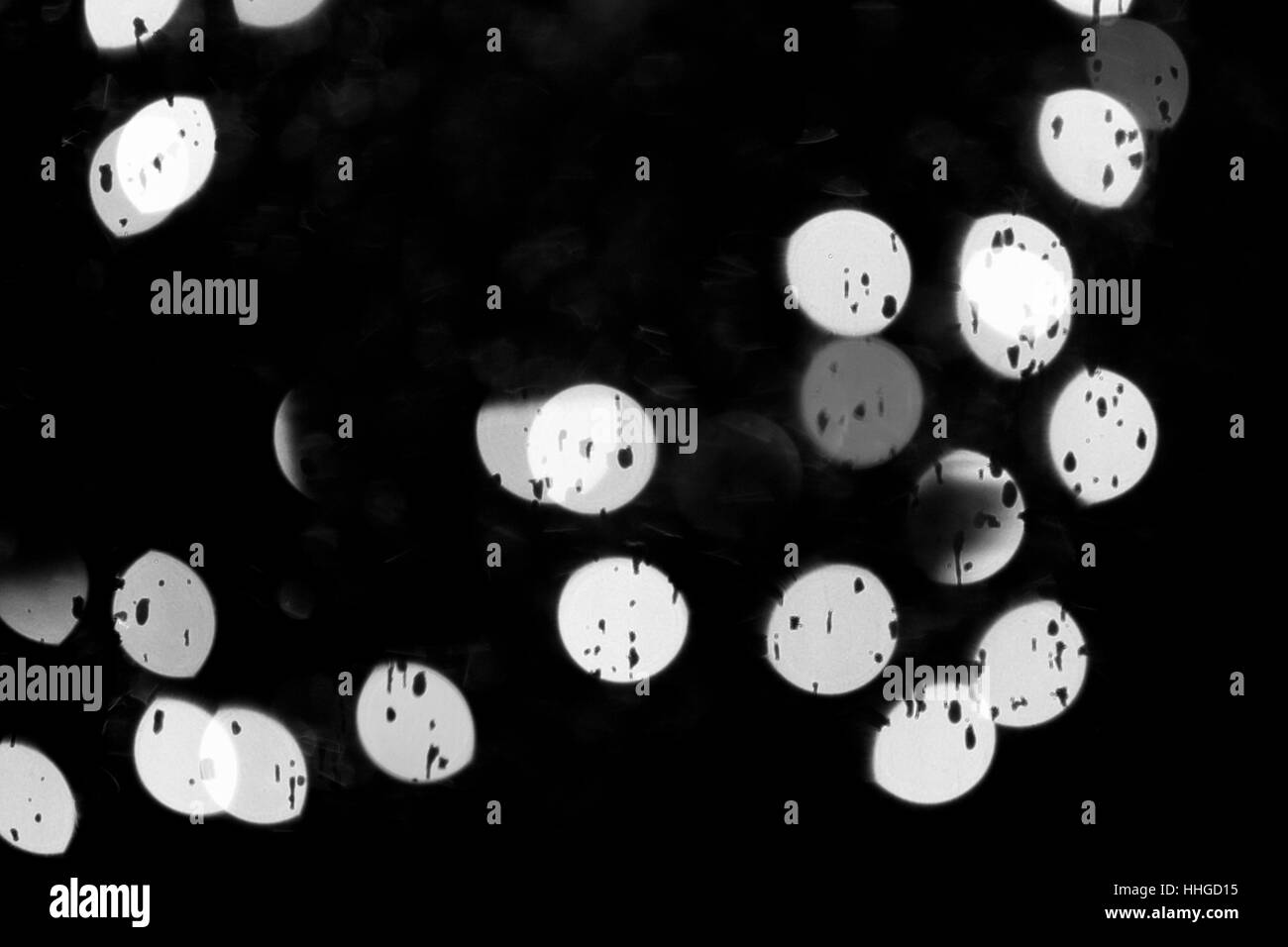 Bokeh's and raindrops on window with black background. Stock Photo