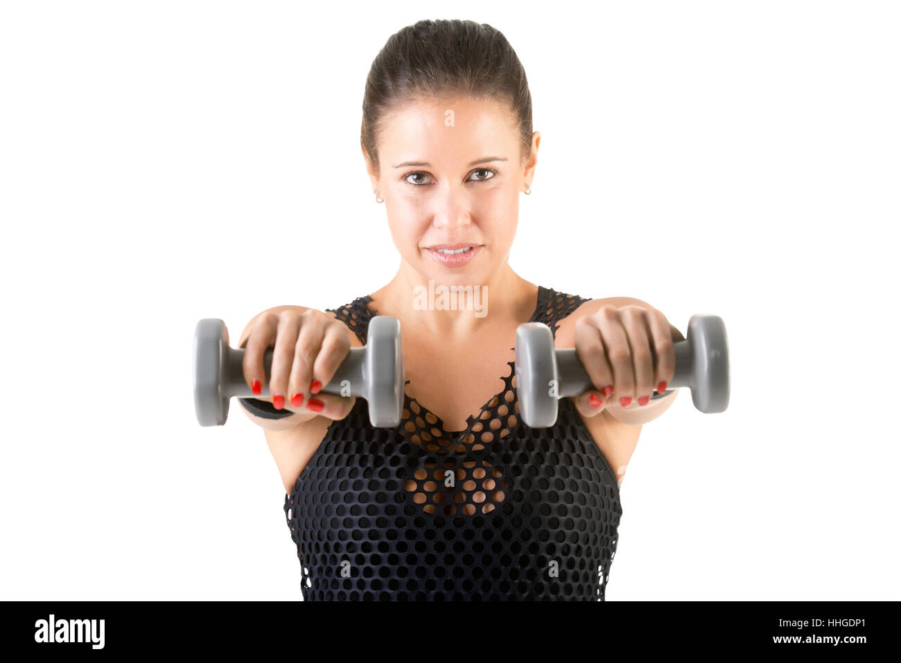 Woman working out with dumbbells at a gym, isolated in a white background Stock Photo