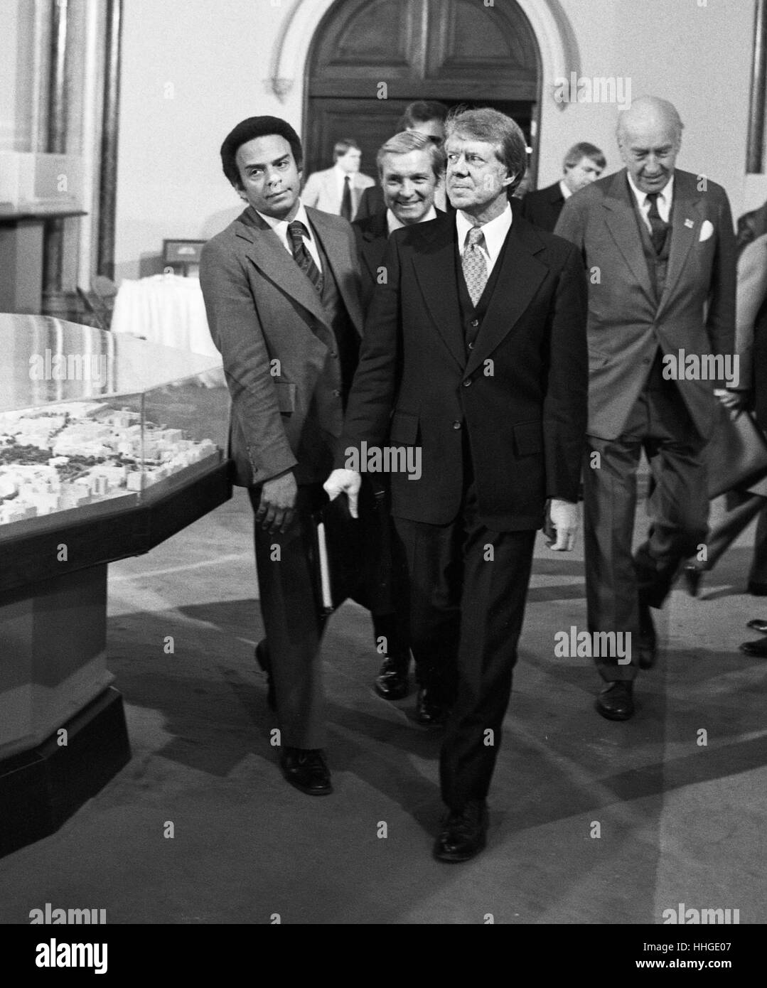 President Jimmy Carter flanked by his Ambassador to the United Nations, Andrew J. Young (left), walk into a meeting at The Smithsonian Institution's Castle building in 1977. Stock Photo
