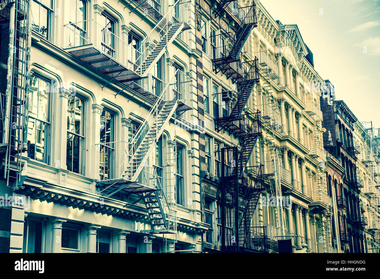 New York City view of exterior facade on ornate old apartment building residence with fire escapes seen from lower Manhattan, NY Stock Photo
