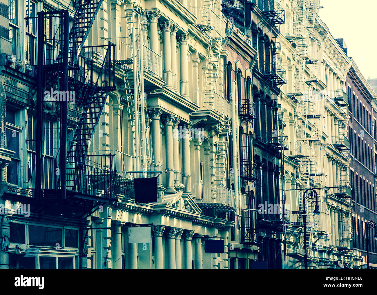 New York City view of exterior facade on ornate old apartment building residence with fire escapes seen from lower Manhattan, NY Stock Photo