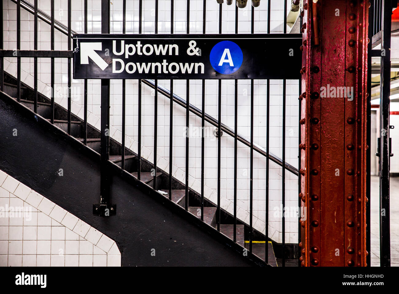 New York City Subway inside and underground with steps and directional sign for Uptown Downtown A train. Stock Photo