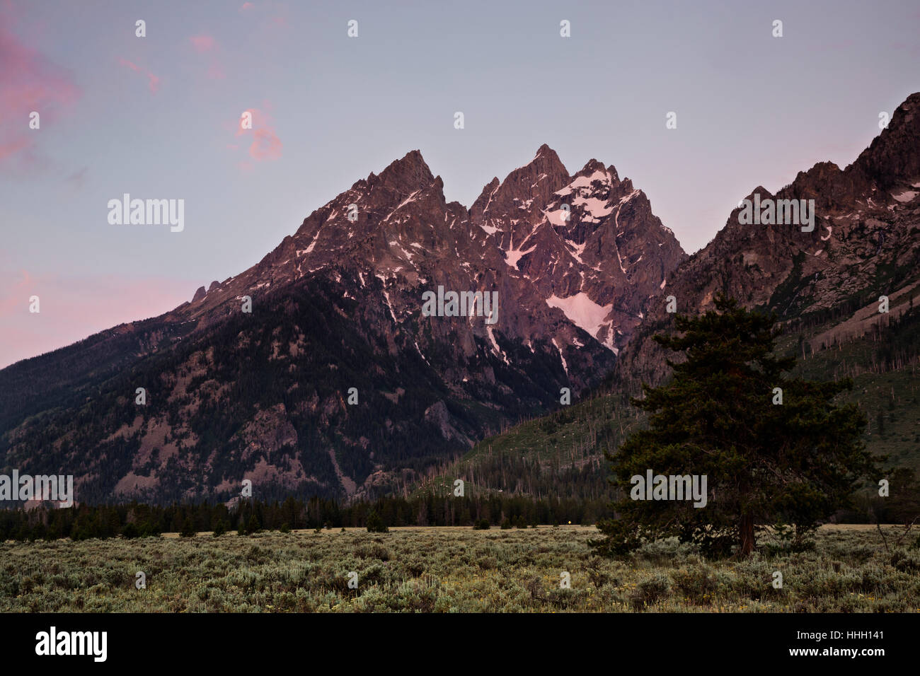 WYOMING - Sunrise on the Cathedral Group composed of Teewinot Mountain, The Grand and Mount Owen in Grand Teton National Park. Stock Photo