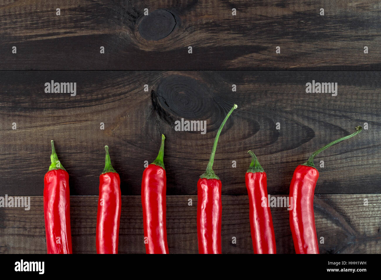 cayenne chilli peppers on wooden background Stock Photo - Alamy