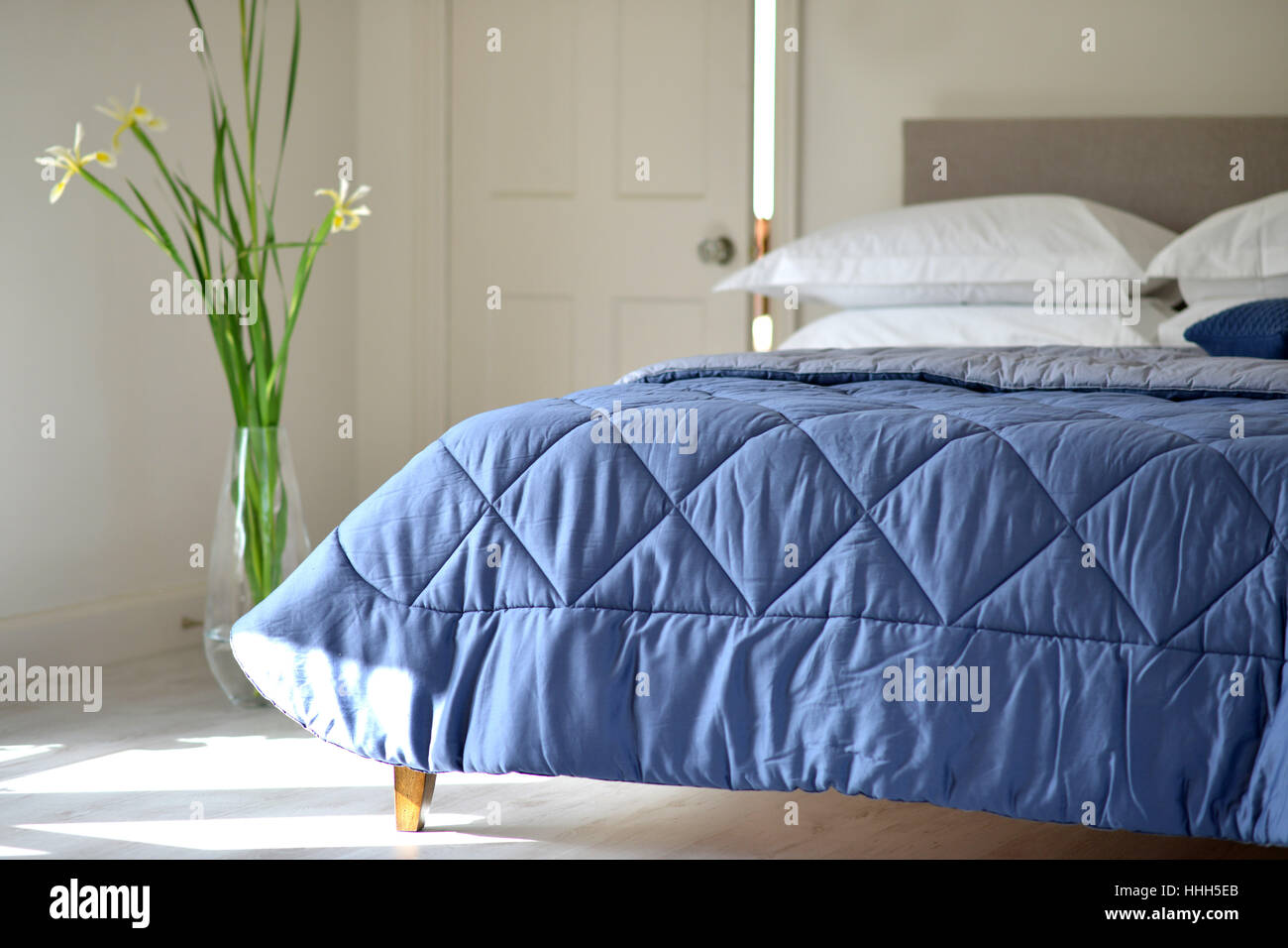 Bed in bedroom setting with luxury bedspread Stock Photo Alamy