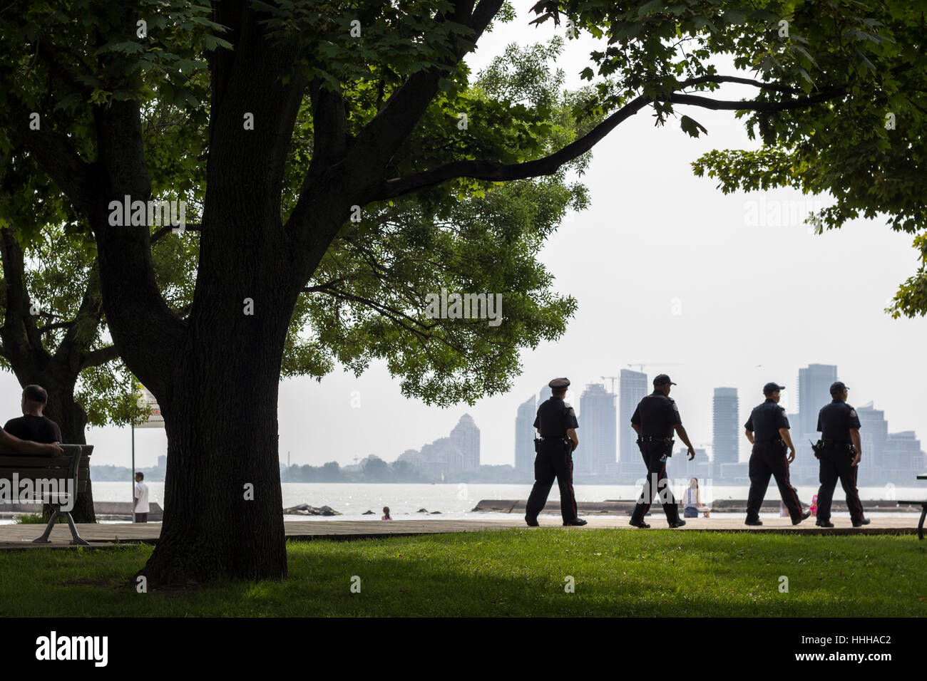 Four policeman walking by the beach in Sunnyside park, Toronto, Canada Stock Photo