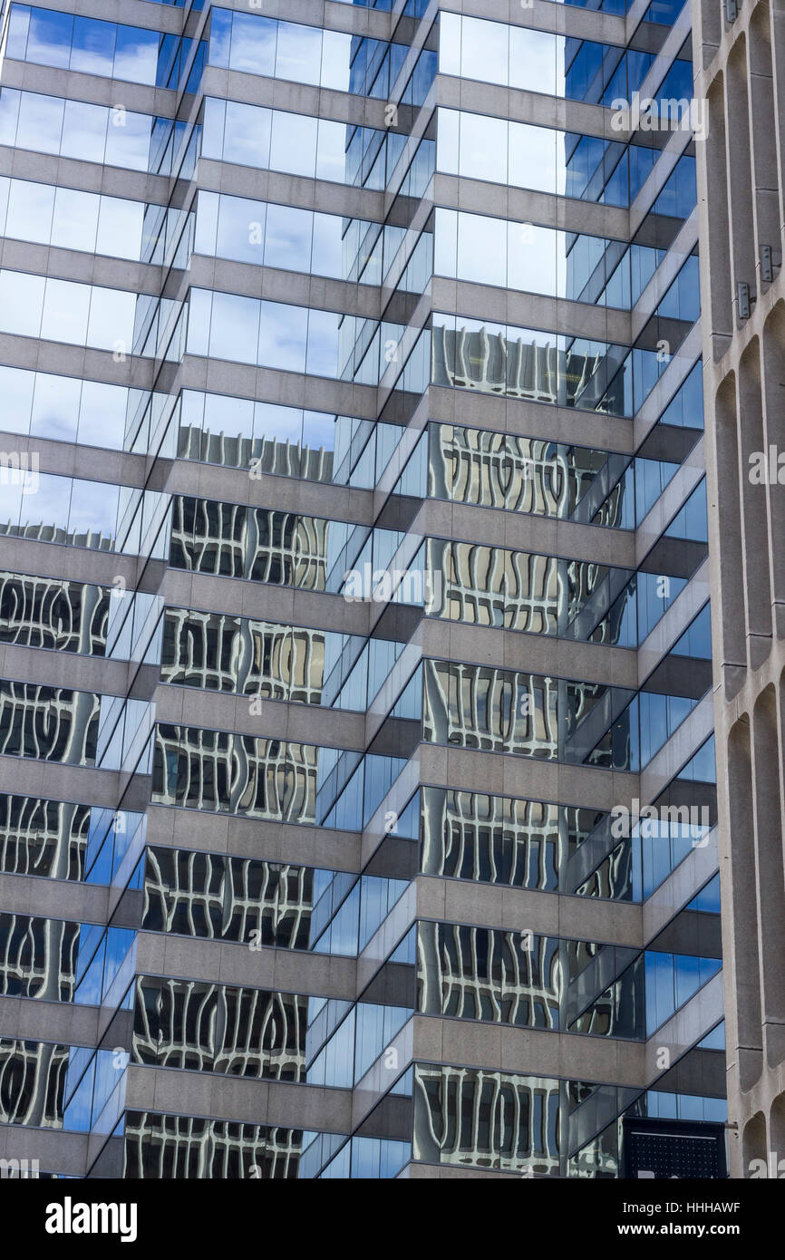 Reflections on city building glass windows Stock Photo